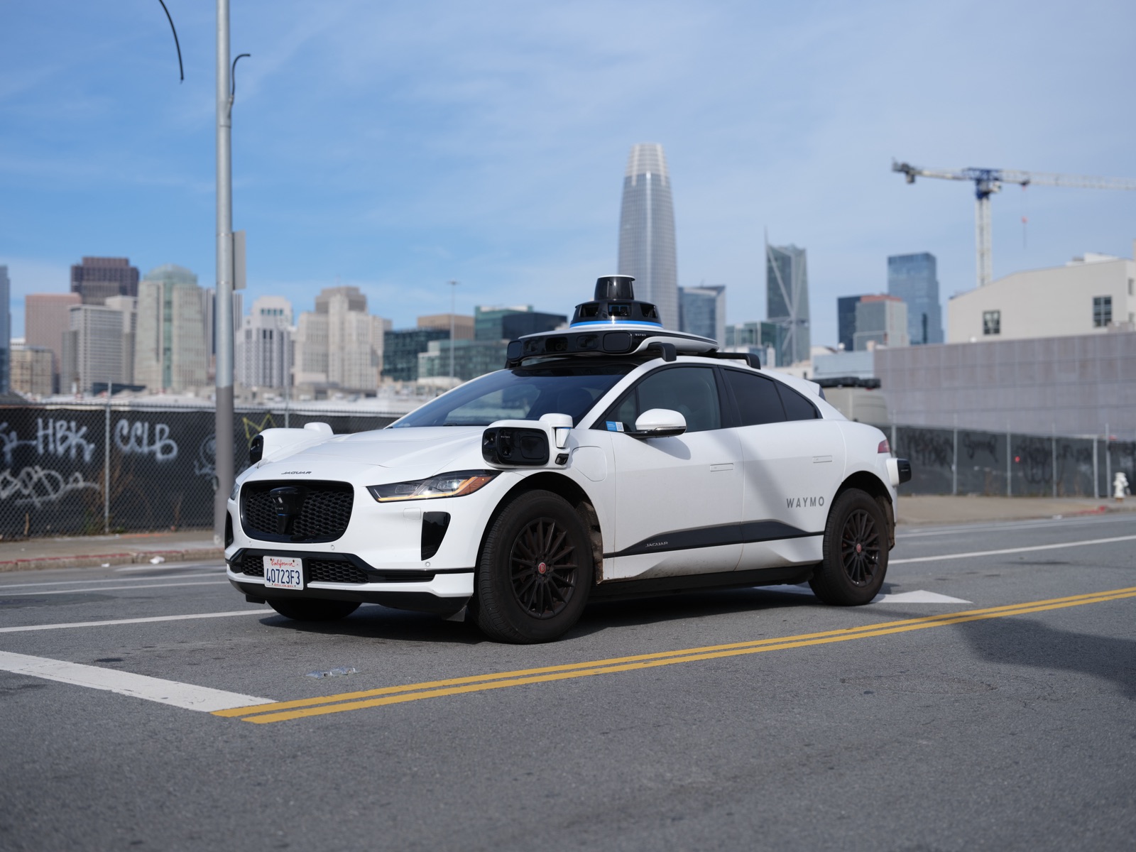 Un robotaxi Waymo, une Jaguar I-Pace autonome équipée de capteurs, dans une rue de San Francisco