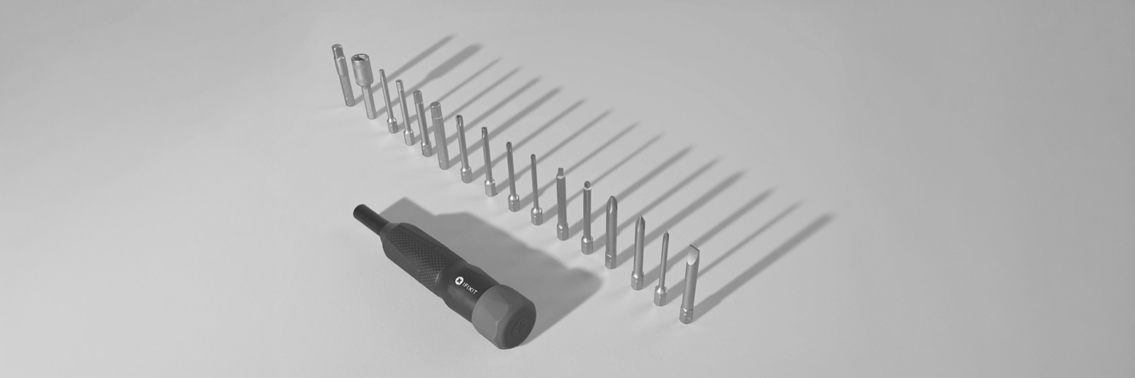 Le kit de tournevis iFixit Megalodon avec son manche et ses seize embouts longs alignes
